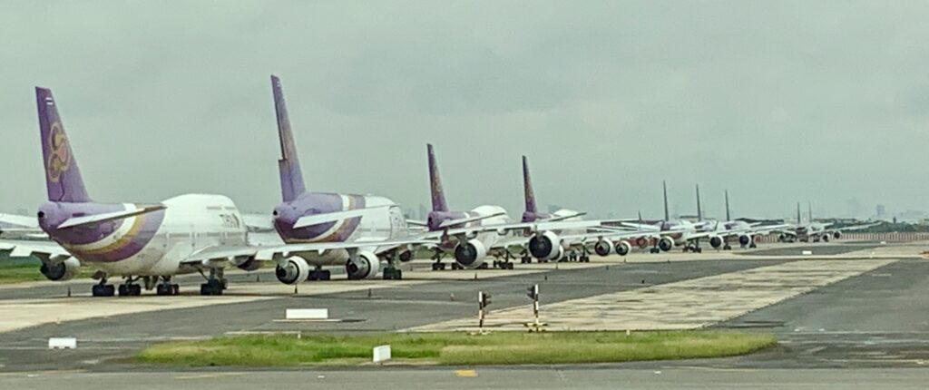 a group of airplanes on a runway