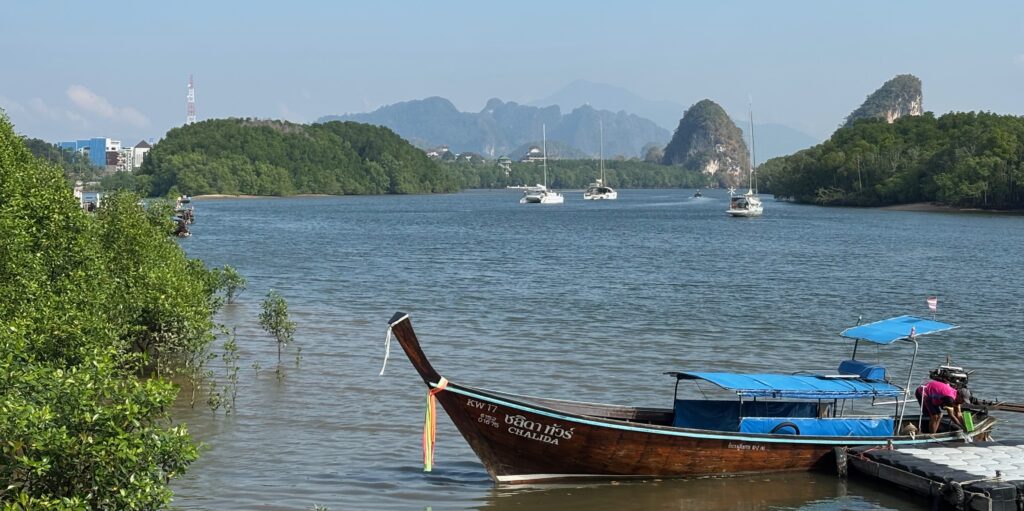 a boat in the water with Yulong River in the background