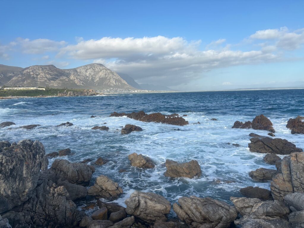 a rocky beach with waves crashing on rocks