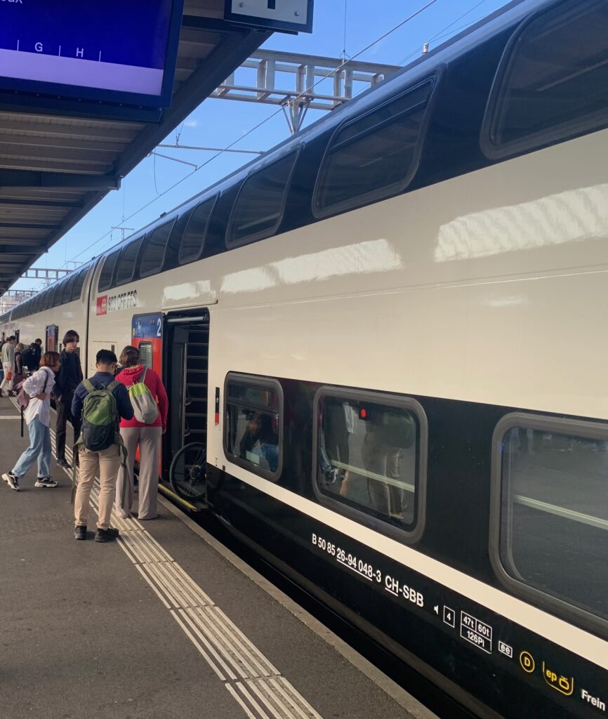 a group of people standing at a train station