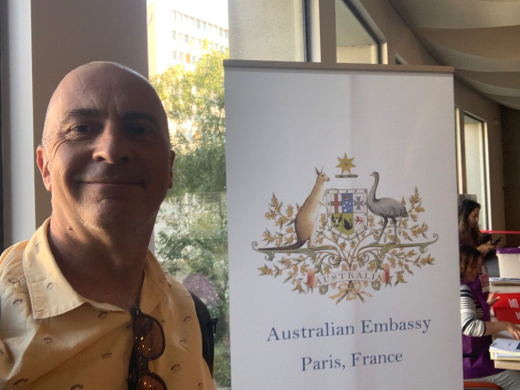 a man standing in front of a sign