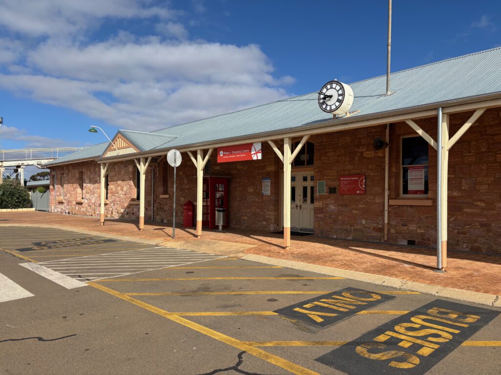 a brick building with a clock on the roof