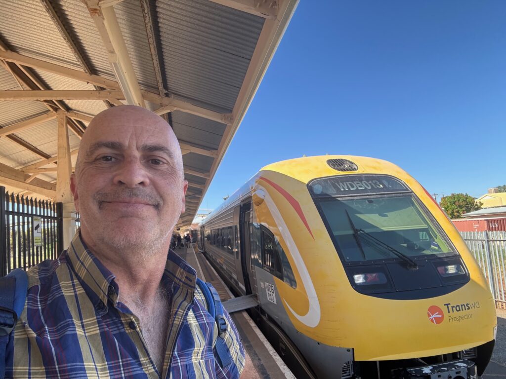 a man taking a selfie at a train station
