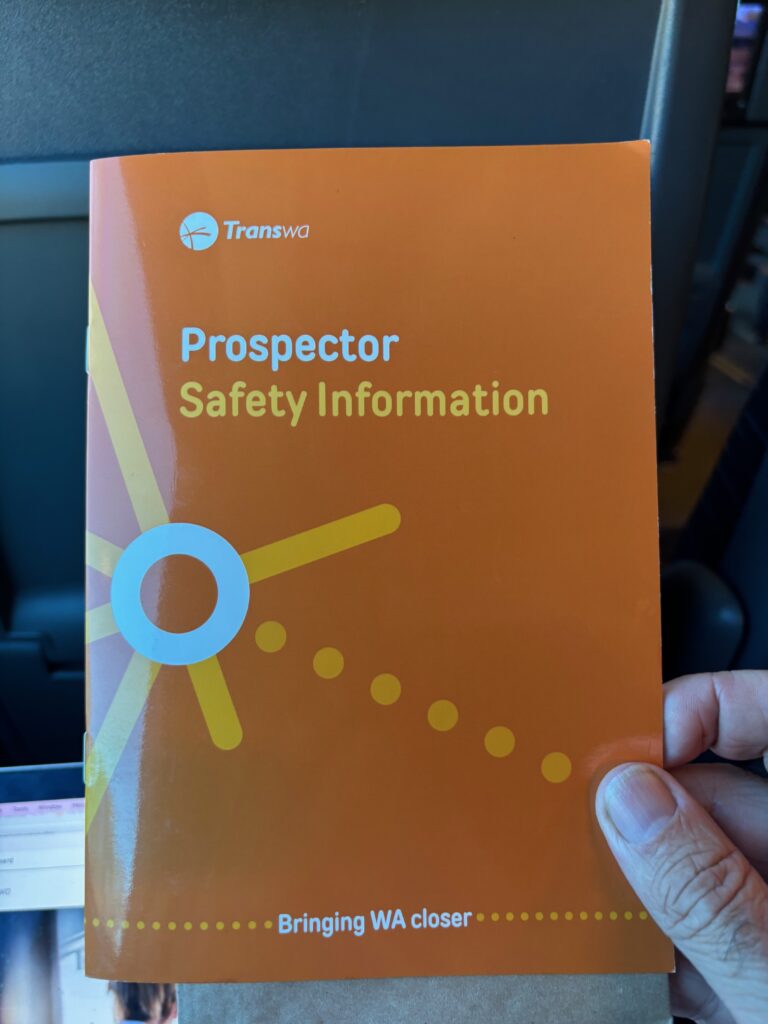 a hand holding an orange book