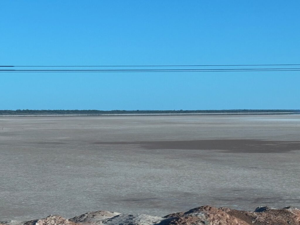 a large flat area with rocks and a blue sky