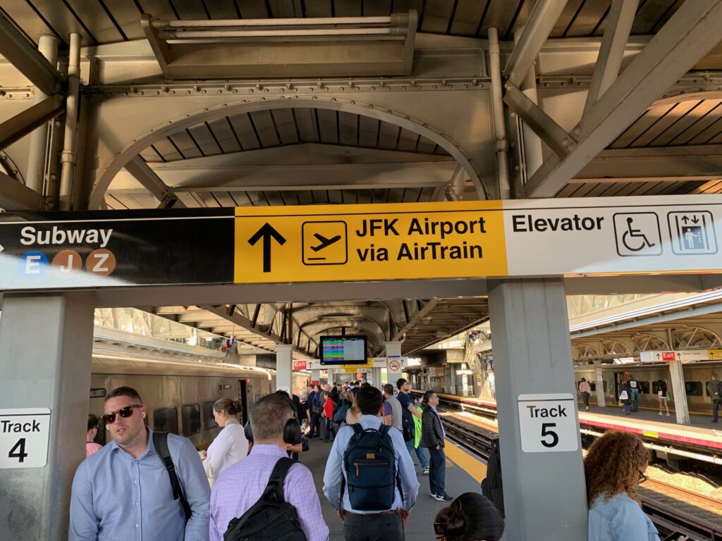 a group of people walking in a train station