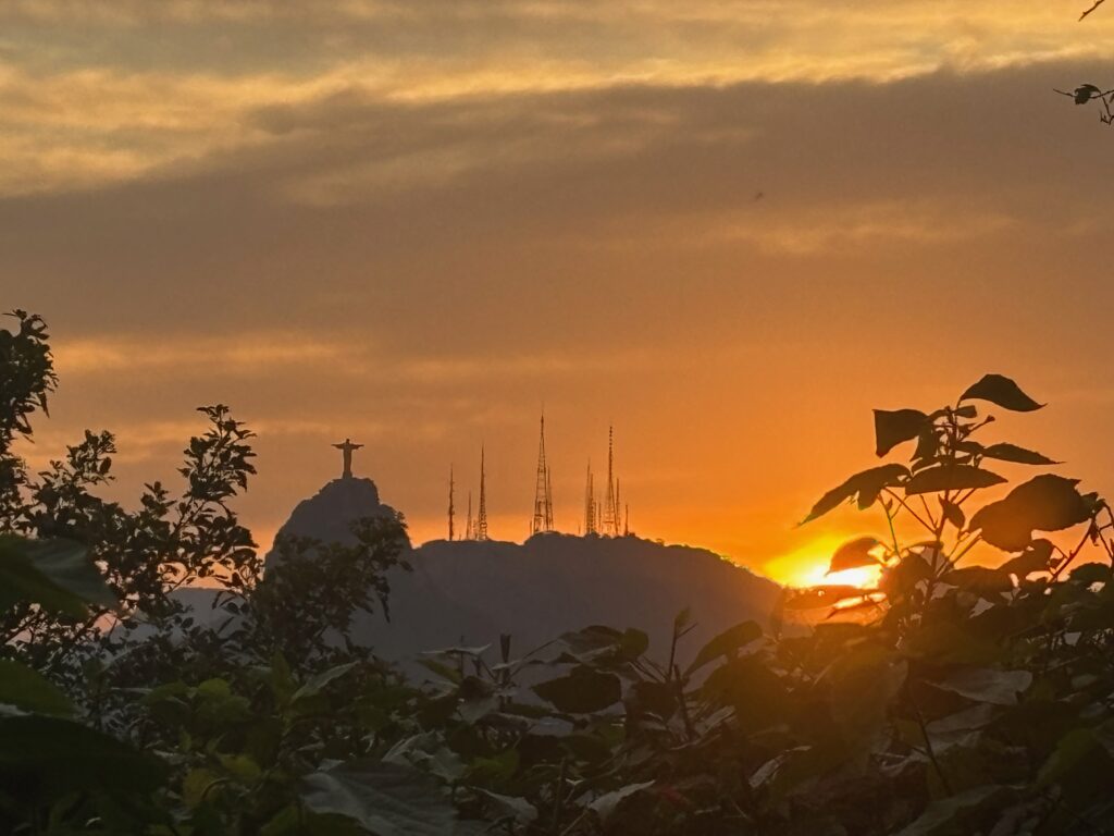 a sunset over a mountain