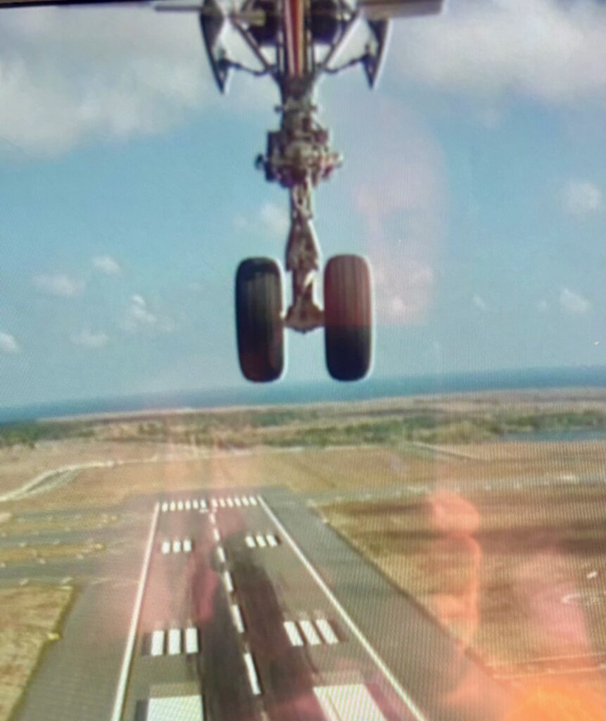 a plane flying over a runway