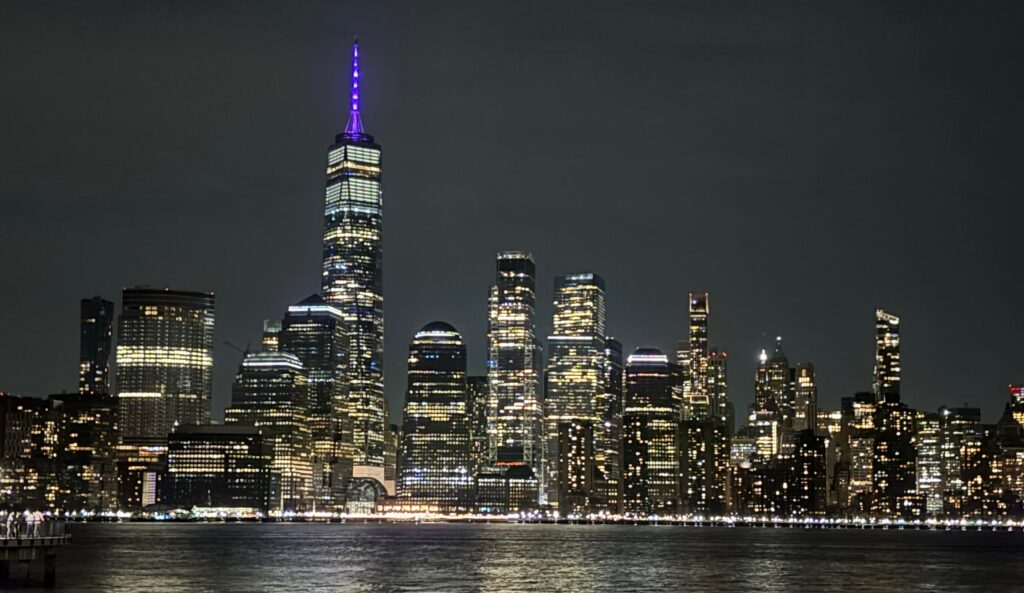 a city skyline at night with lights on