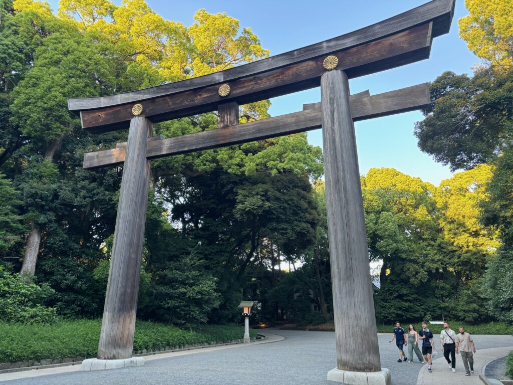 a large wooden archway with people walking around