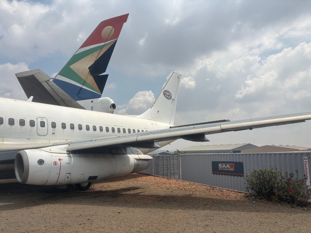 a plane parked in a gravel area