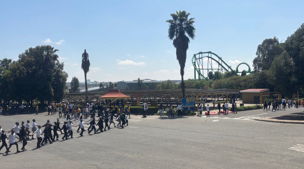a group of people walking in a parking lot