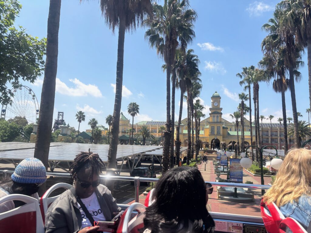 people on a bus in front of palm trees
