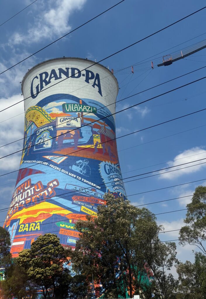 a tall tower with a painted tower with Riviera in the background
