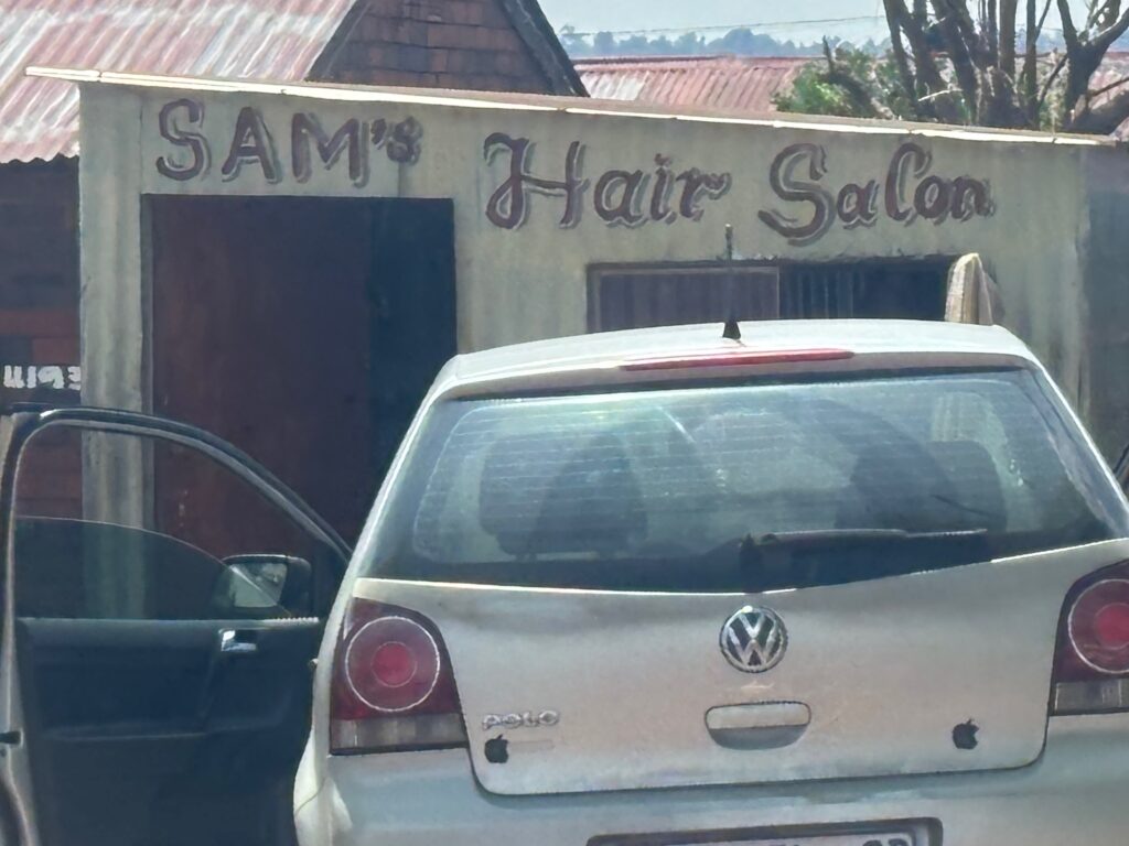 a car parked outside of a hair salon