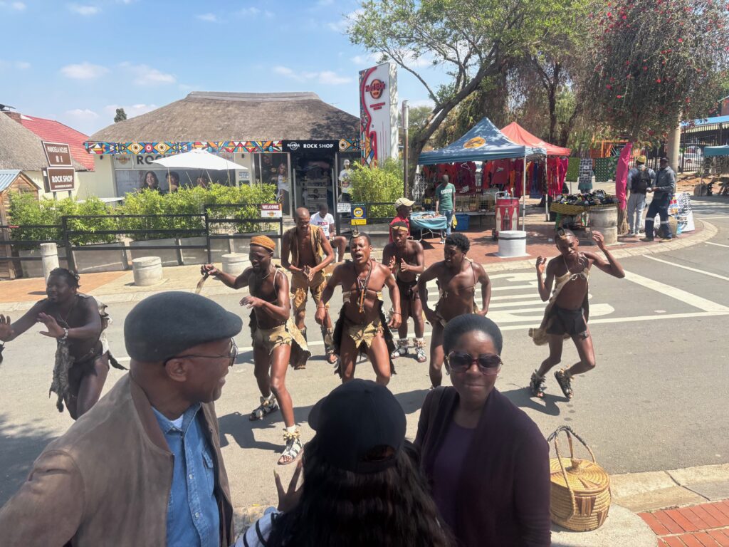 a group of people in clothing dancing on a street