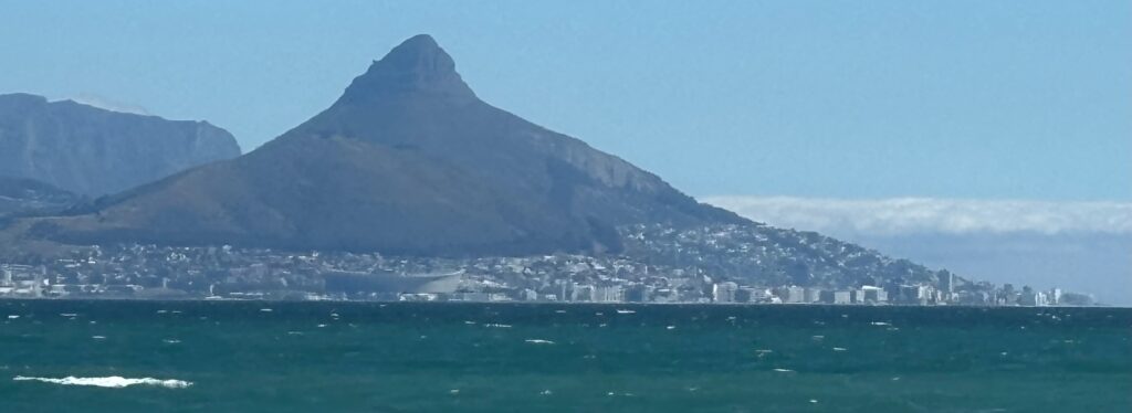 a body of water with a mountain in the background