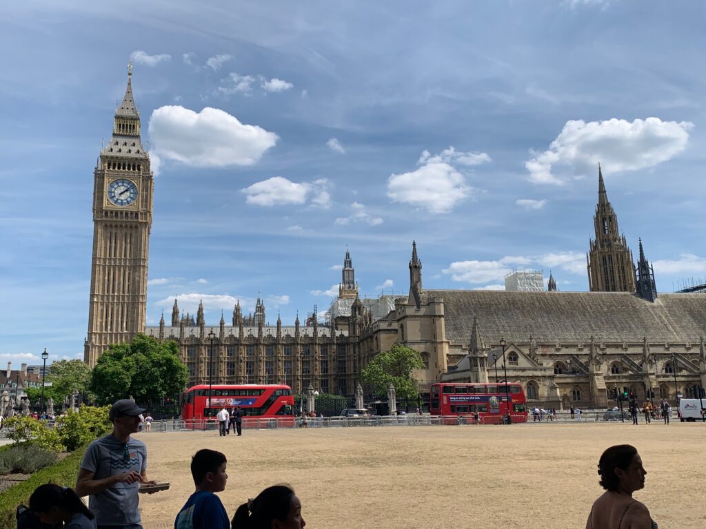 a large clock tower in front of a large building
