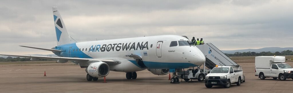a white airplane with blue text on it