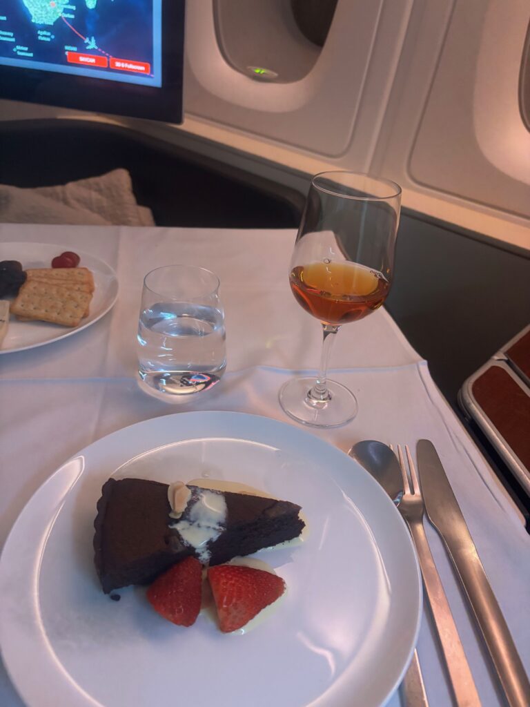 a plate of food and a glass of wine on a table