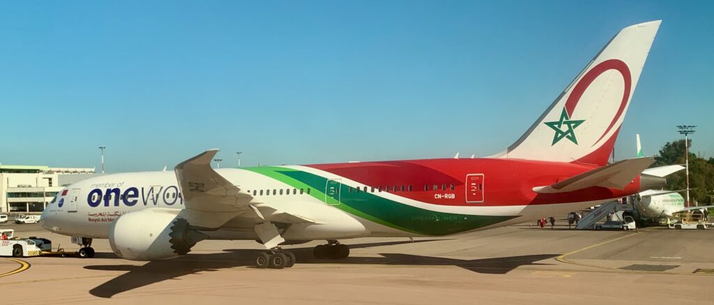 a red and green airplane on a runway