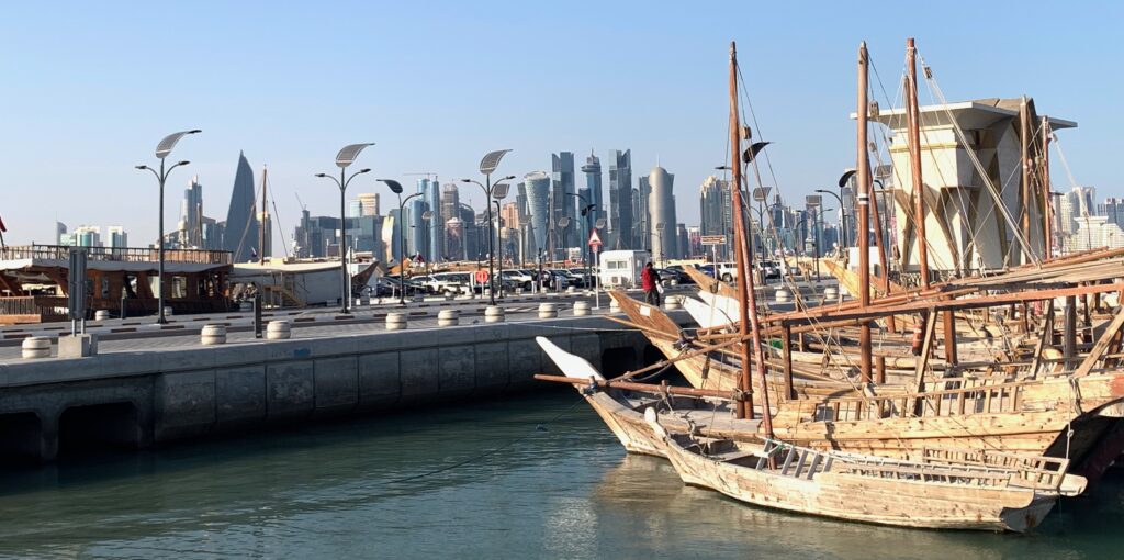boats in a harbor with a city in the background