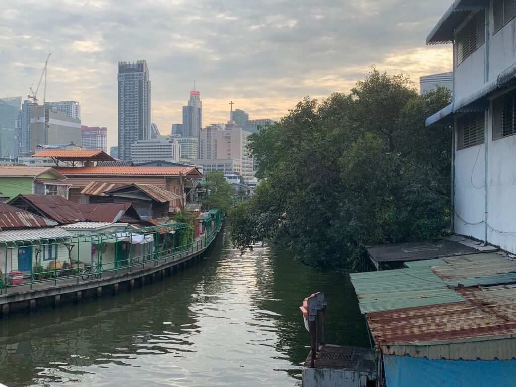a river with buildings and trees in the background