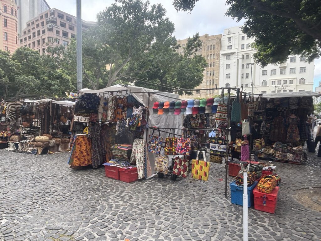 a street market with many items and bags
