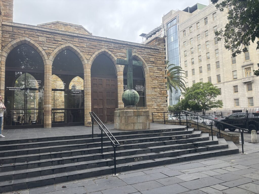 a stone building with a cross and a ball on top