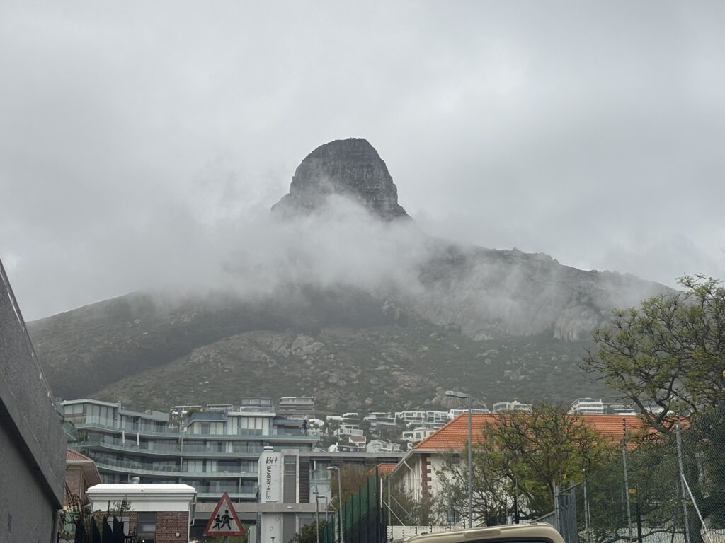 a mountain with clouds in the sky