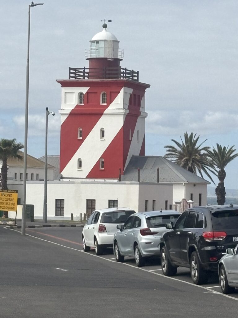 a lighthouse with a red and white striped tower