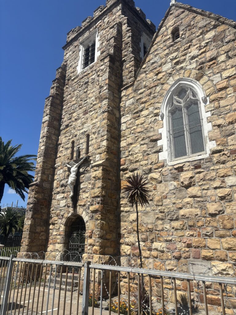 a stone building with a cross on the wall