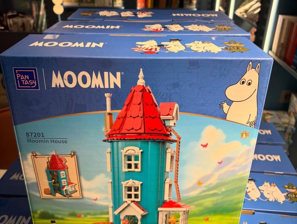 a blue box with a building and a cartoon character on it