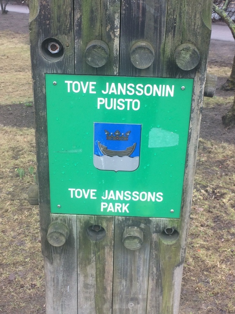 a sign on a wooden post