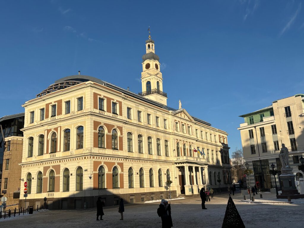 a building with a tower and people walking around