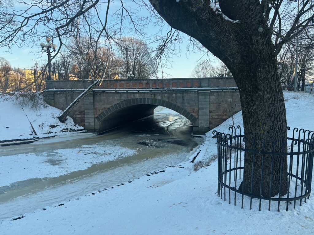 a bridge under a snow covered river