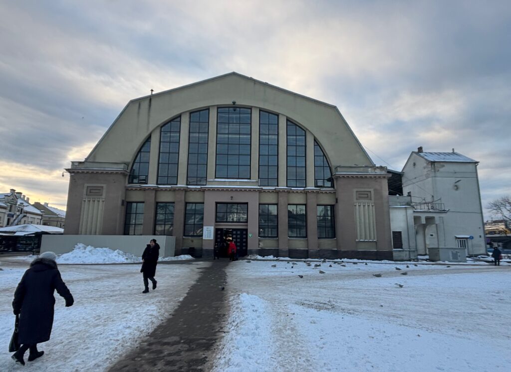 a building with a large arched roof and a snow covered ground