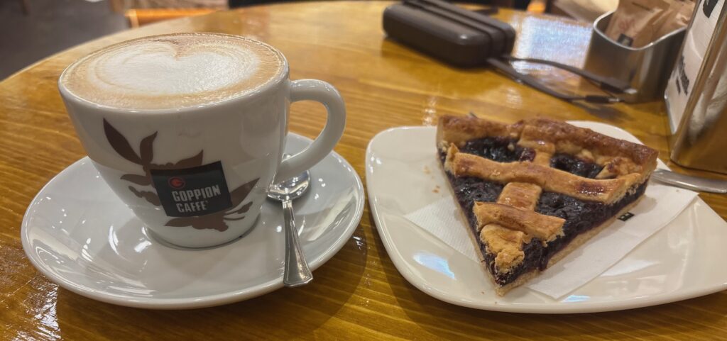 a plate of pie and a cup of coffee on a table