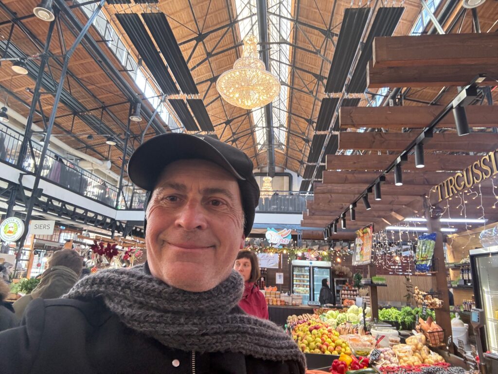a man taking a selfie in a market