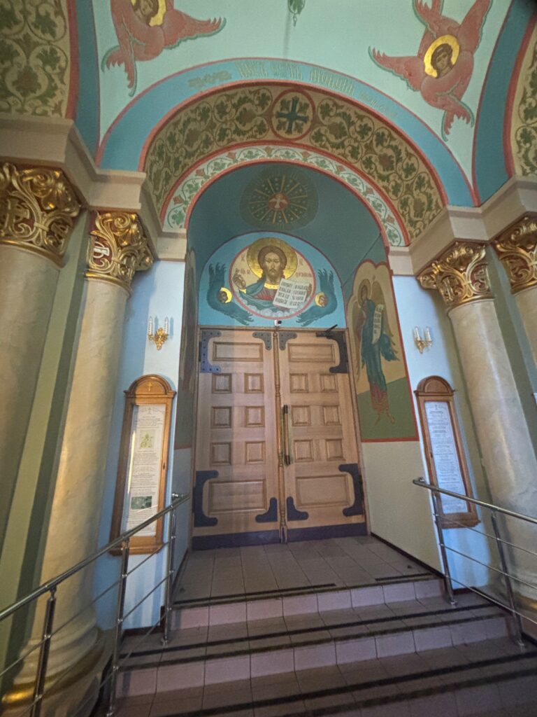 a hallway with a door and a railing