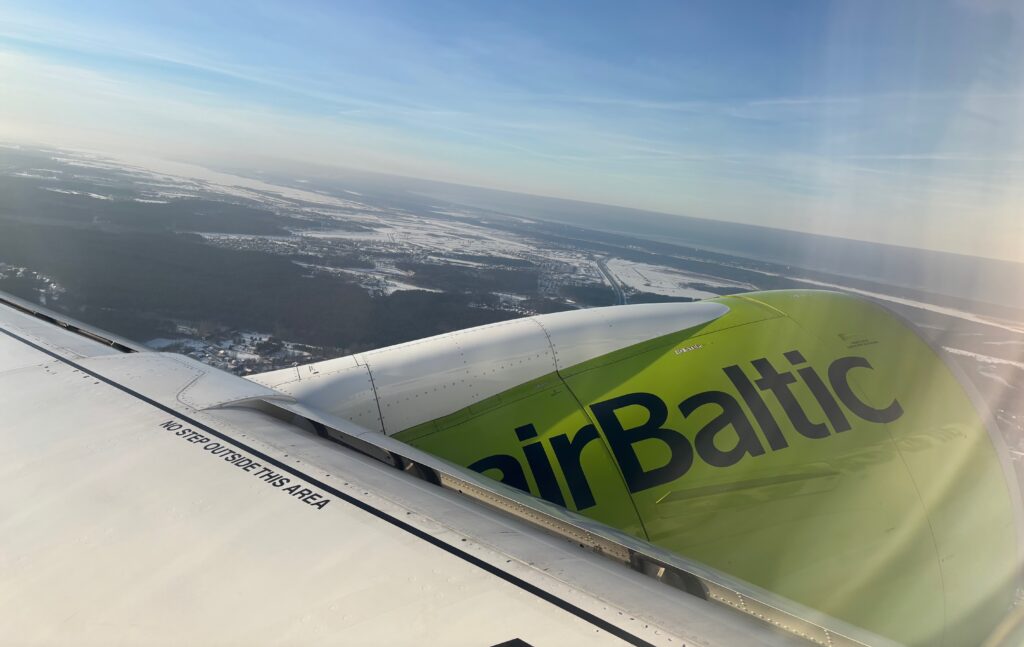 an airplane wing with a green and black logo