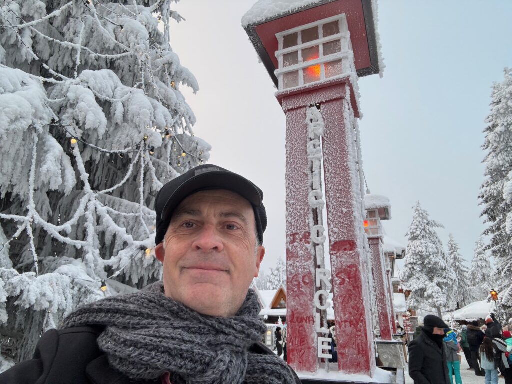a man taking a selfie in front of a tall tower