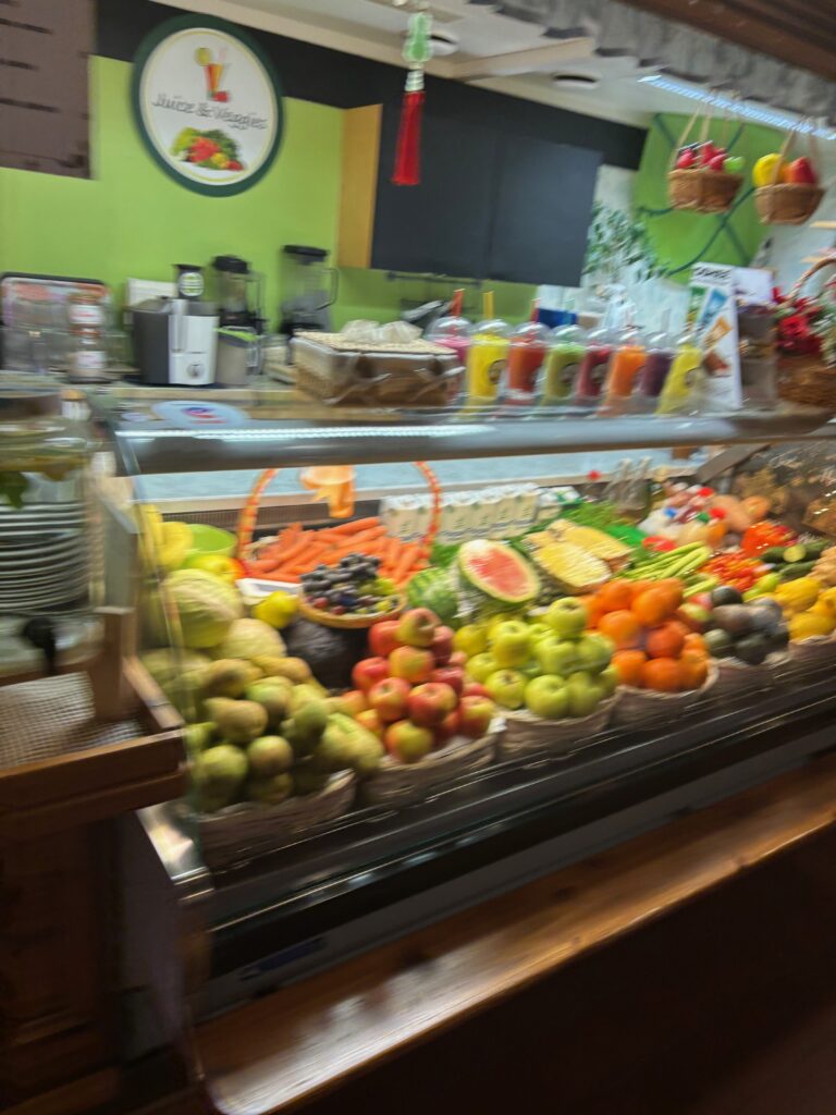 a display case of fruit and vegetables
