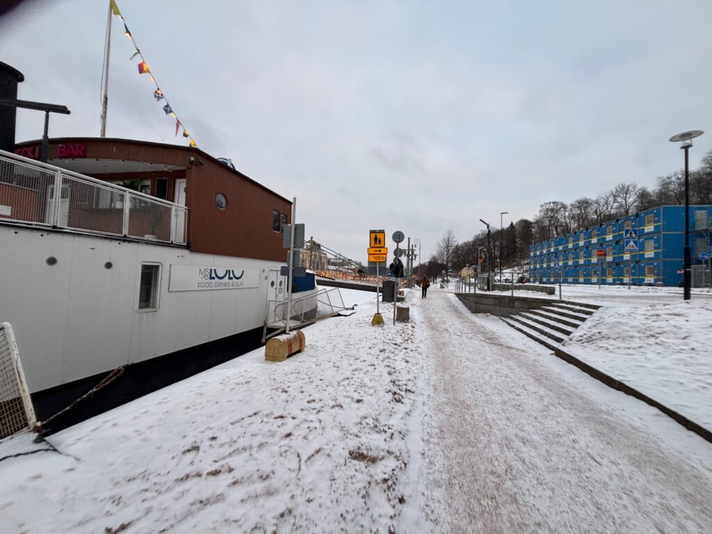 a snow covered path with a boat on it