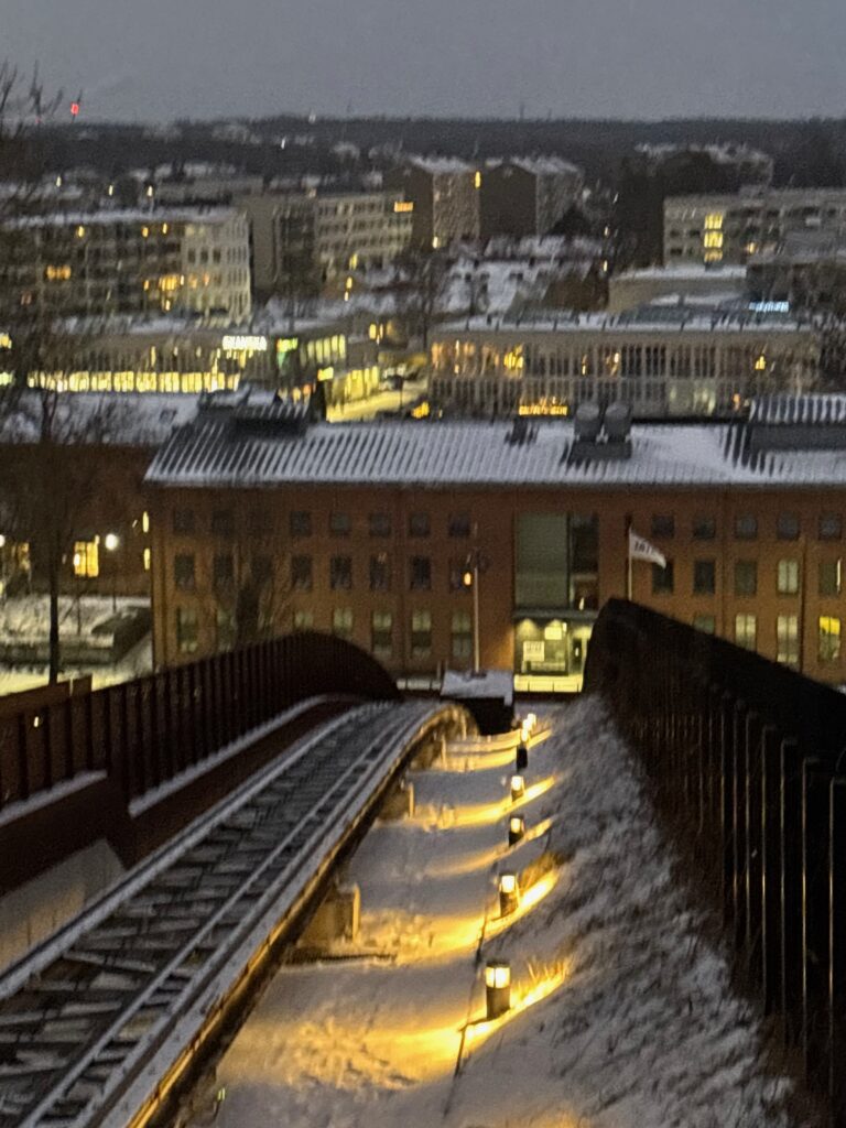 a snowy city with a train track
