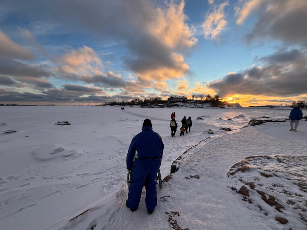 a group of people walking in snow