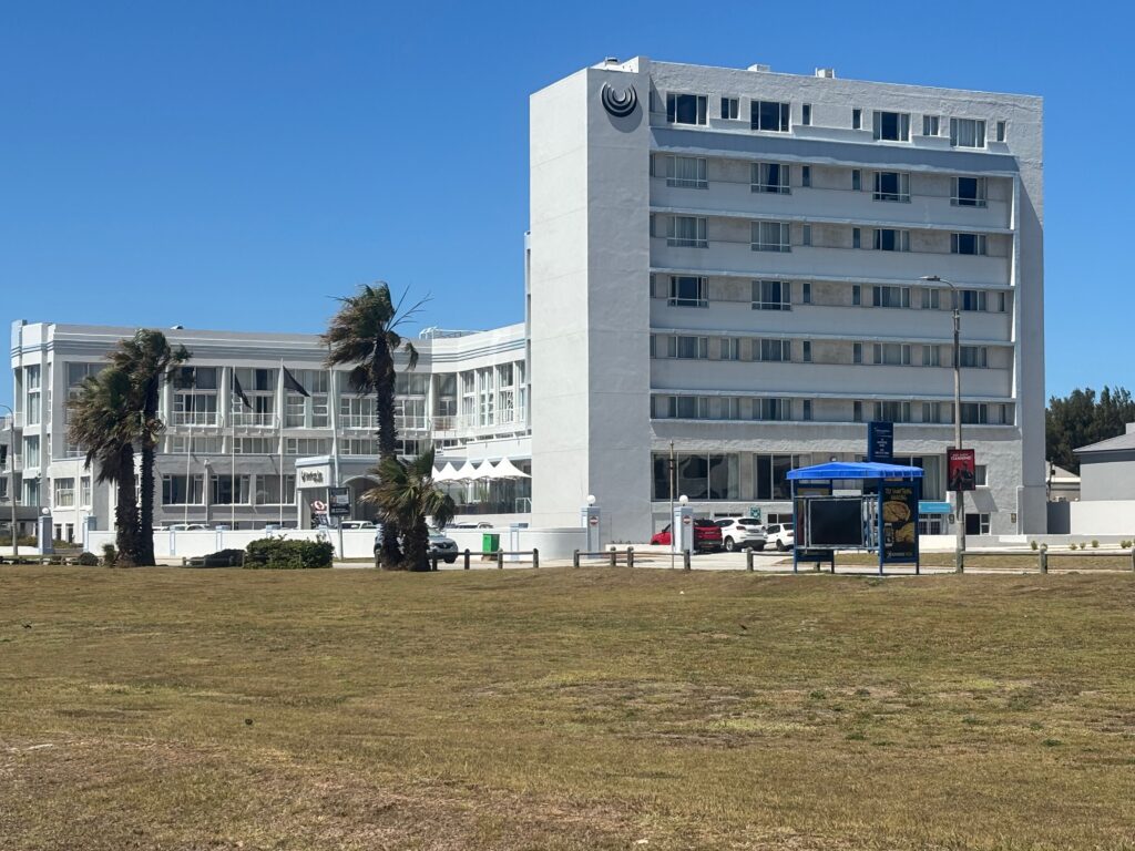 a large white building with a grassy area