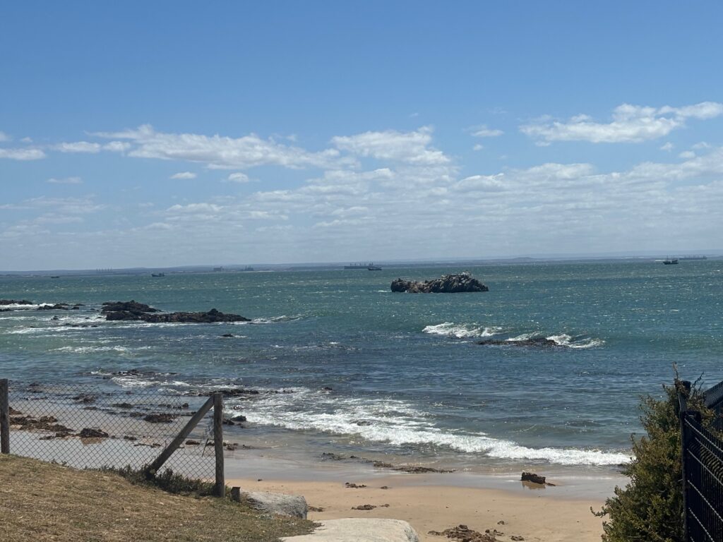 a beach with rocks and a fence