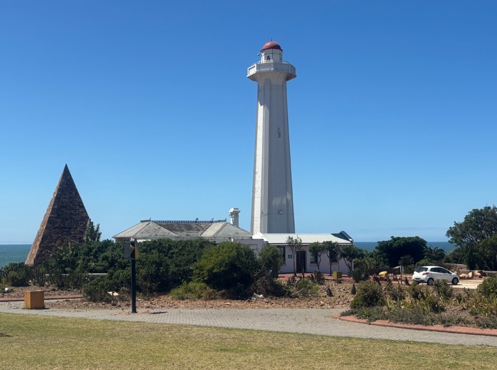 a white tower with a red top