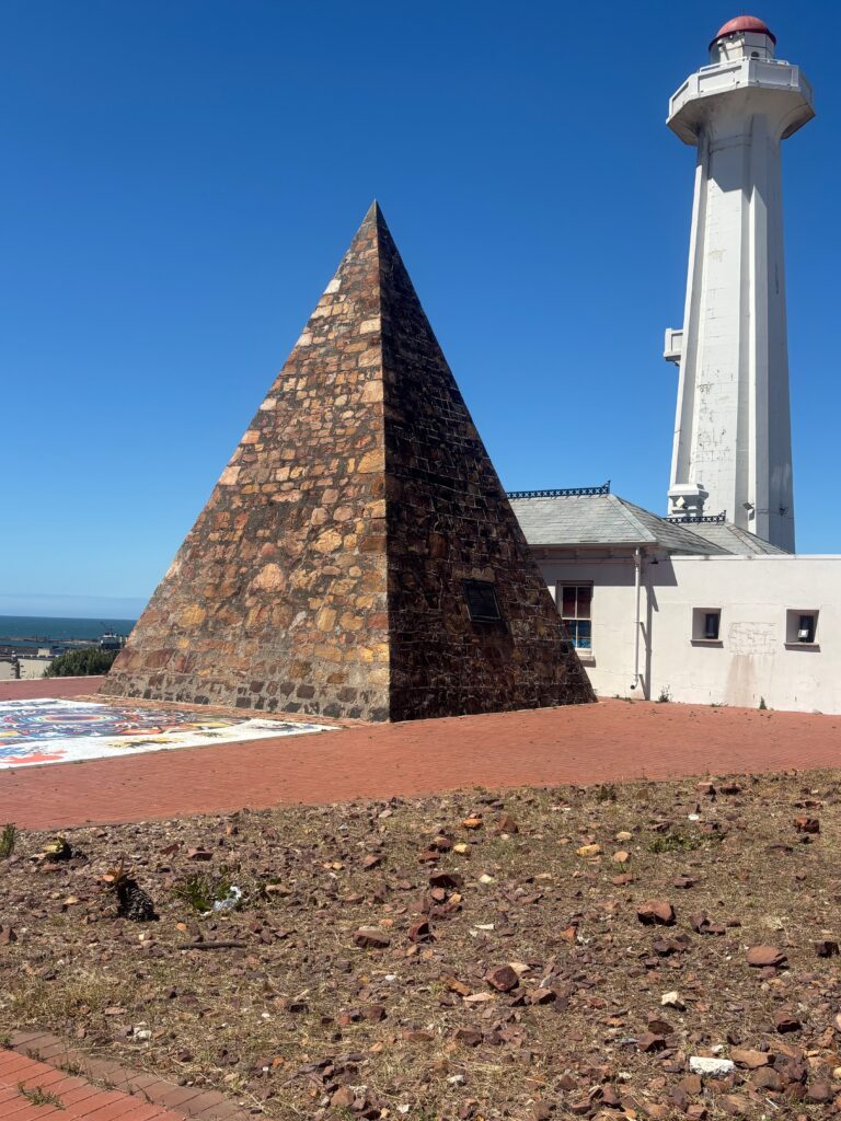 a pyramid shaped building with a white tower